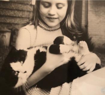 Black and white photo of girl and cat 