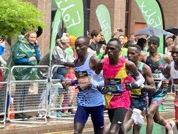 A pack of runners leading a race 