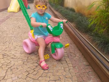 Blond toddler on tricycle 