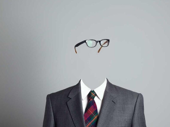 Pair of glasses floating about a suit of men's clothing to portray an invisible man.
