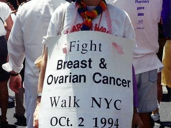 Photo of me with a sign about breast and ovarian cancer, 1994 NYC PRIDE march.