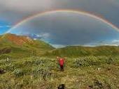 Happy person under rainbow.