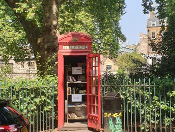 photo of a mini library in a red phone box