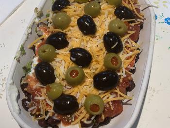 7-layer dip with avocado mixed in with Greek yogurt, black and green olives, etc..