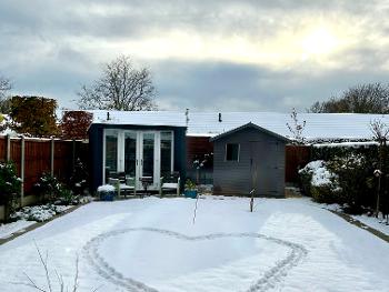 Image of heart print in snowy garden.