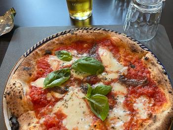 Pizza Napoli with tomato, buffalo mozzarella, anchovies, basil.