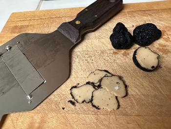 Freshen shaved black summer truffles with shaver appliance.
