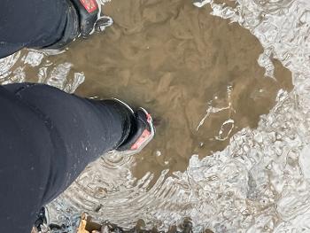 Very deep puddle with my feet covered in muddy water