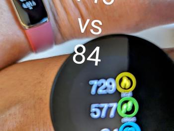 Two fitness trackers, one showing 84 beats a minute, the other showing 146.