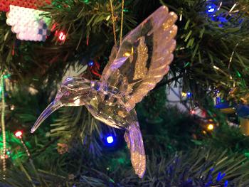 Hummingbird ornament on a Christmas tree.
