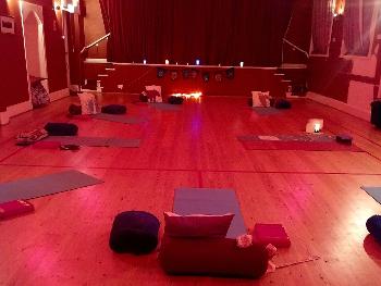 FriYay Night yoga laid out with mats and props, dim lighting and aromatherapy!