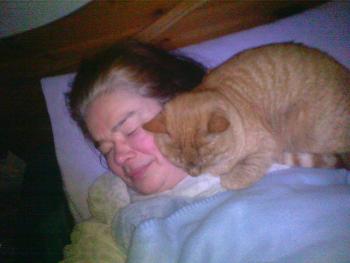 Me and my ginger cat, Jones.  I'm in bed and he's lying on my face! 