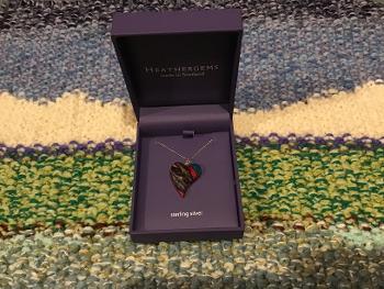 Heart shaped heather gem pendant in its box.