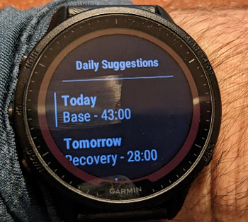 Photo of face of running watch showing Daily Suggestions list.