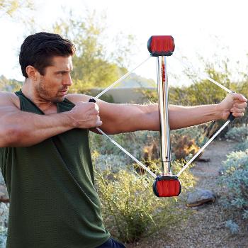 Man using Bullworker device for a bow-draw tension exercise. Handles support compression.