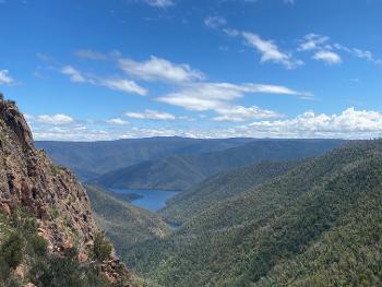 Hills and valleys covered by Australian bush with a large lake in the centre. 