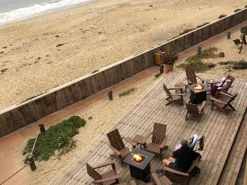 Beach and fire pits in the morning on the deck below the room. 