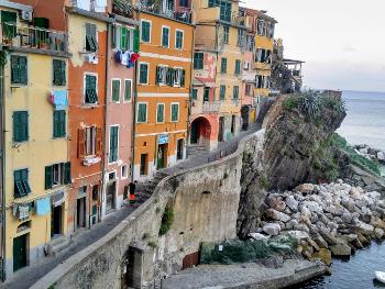 Beautiful Italian seaside village with tall colourful houses clinging to the bay