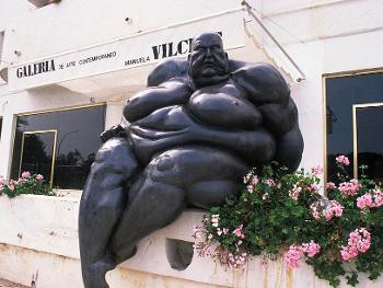 Statue of a fat man by Carl Purcell