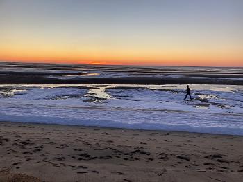 Ha! Success! 😂 My brother striding across the snowy beach at sunset.
