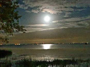 A view over Lough Neagh with the full moon reflecting on the water.