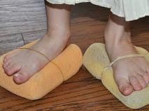 Colour photo of feet with sponges strapped to them 