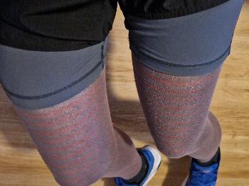 Legs of a runner wearing red stripy tights