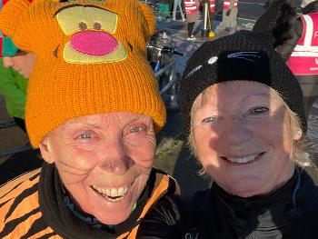 Parkrunners dressed as a tiger and black cat.  