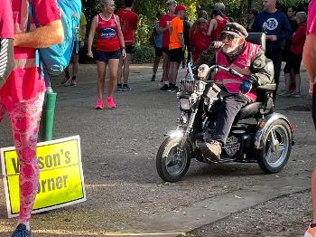 Elderly parkrun volunteer on a trike