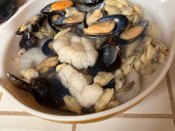 Very large bowl of both fresh and frozen seafood. 