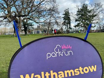 Me running behind the Walthamstow parkrun sign