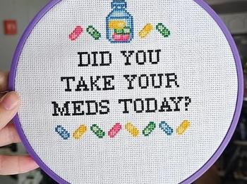 Cross stitch sign to take your meds.