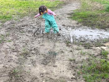 Child playing in mud 