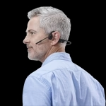 Male wearing a bone conduction headset, which sits atop his cheekbone.