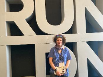 Standing in front in Run LDN sign