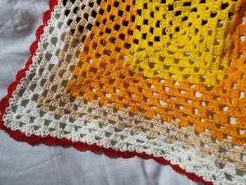 Brightly coloured homemade crochet blanket