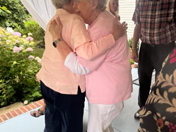 My mum hugging her BFF at 90th party