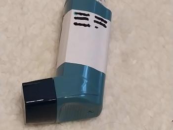 Blue, ventolin inhaler showing sticker with tally marks
