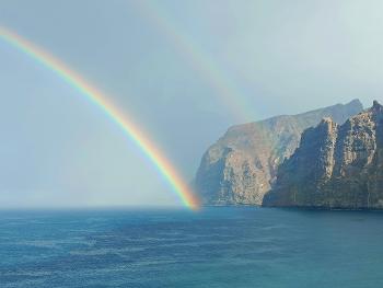 Cliff, ocean and rainbow