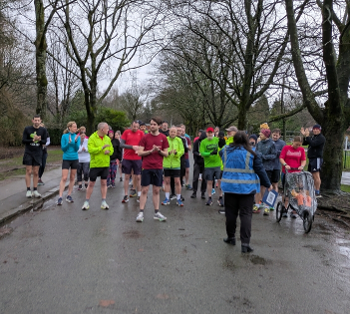 Parkrunners lined up at the start listening to the Run Director's speech.