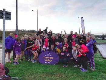 Fordy runners behind the Tramore Valley parkrun sign 