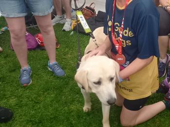 Runner cuddling trainee guide dog 